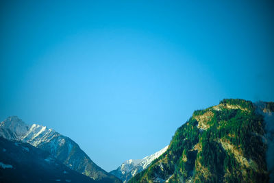 Low angle view of mountain against clear blue sky