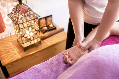 Female masseuse massaging a patient's hand
