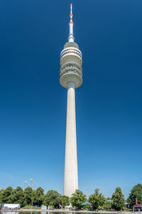 Low angle view of communications tower against blue sky