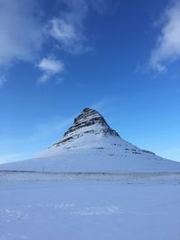 Scenic view of snowcapped mountain against blue sky