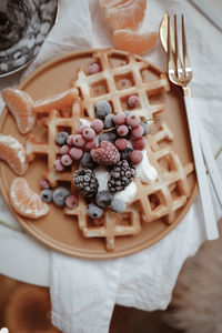 High angle view of food on table, waffles, fruits