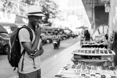 Side view of man looking away in city