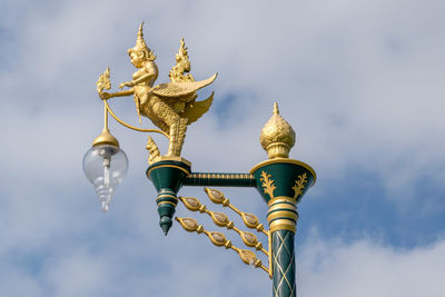 Low angle view of sculpture against building