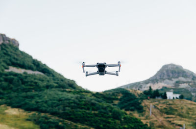 Flying drone with camera in mountains