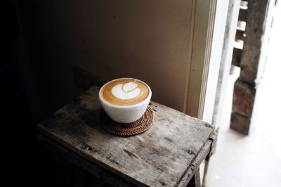 High angle view of cappuccino on wooden table