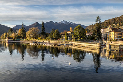 Scenic view of lake by buildings against sky