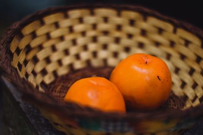 Close-up of orange fruits in basket