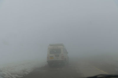 Car on road against sky during winter