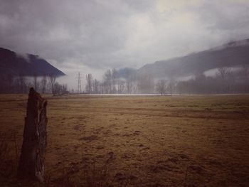 Scenic view of mountains against cloudy sky
