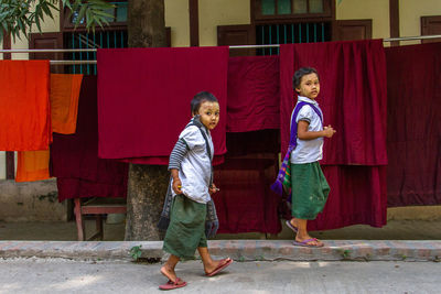 Full length of boy with red umbrella