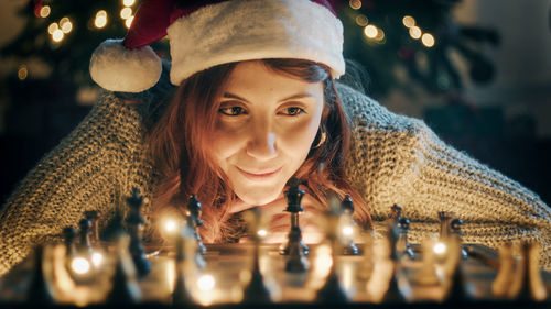 Girl plays chess on christmas mood