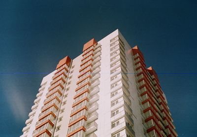 Low angle view of modern building against blue sky