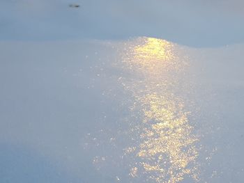 Firework display over lake against sky during winter