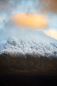 Scenic view of snowcapped mountains against sky during sunset