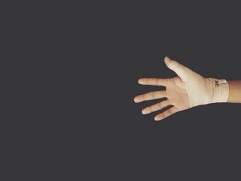 Cropped image of man over black background