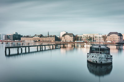 Boats in river with buildings in background