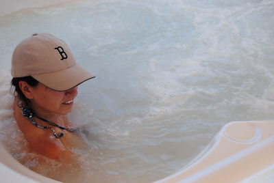 Woman taking bath in hot tub