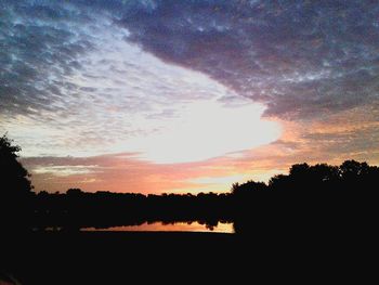 Silhouette trees against sky during sunset