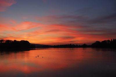 Scenic view of lake against orange sky