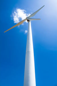 Low angle view of windmill against blue sky