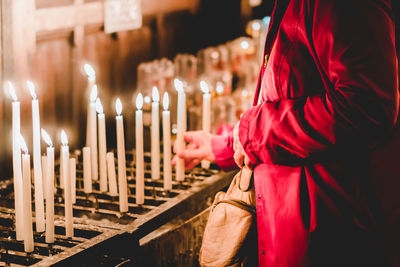 Close-up of illuminated candles on temple at night