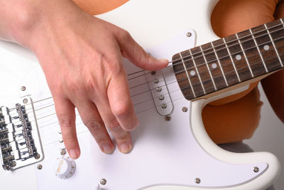 Midsection of man playing guitar