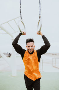 Portrait of athlete holding gymnastics rings