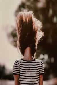 Rear view of boy standing in water