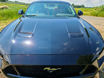 Close-up of vintage car on field