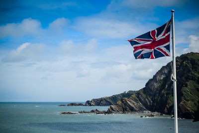 Union flag against scenic seascape