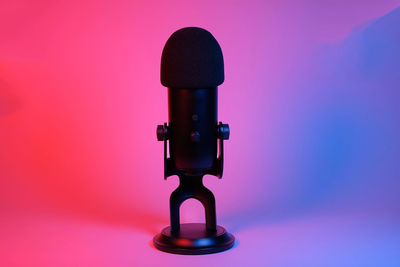 Close-up of microphone against yellow background