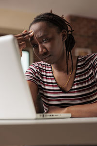 Young woman using laptop at home