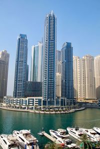 Modern buildings in city against clear sky