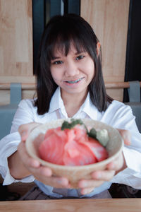 Portrait of smiling woman holding ice cream