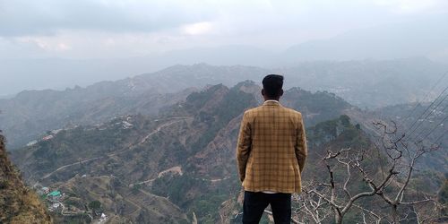 Rear view of man standing on mountain