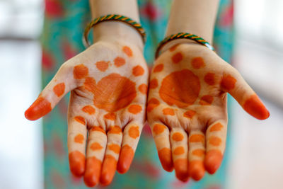 Close-up of hand holding orange