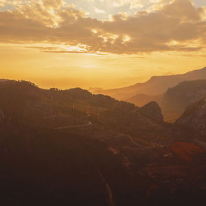 Scenic view of mountains against sky during sunset