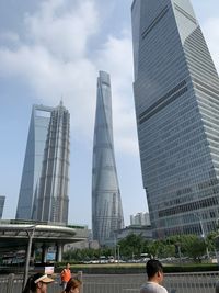 View of modern buildings against cloudy sky