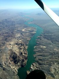 Aerial view of sea and airplane wing