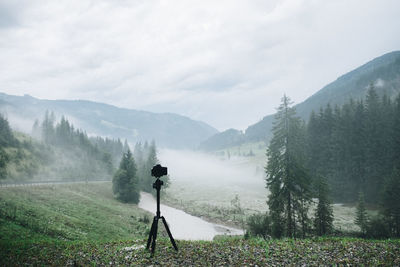 Rear view of people on landscape against sky