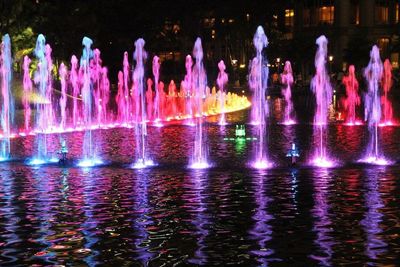 Panoramic view of illuminated lights in water at night