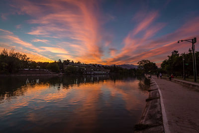 Scenic view of lake against orange sky