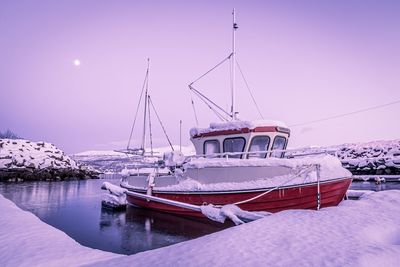 Boat in snow covered landscape