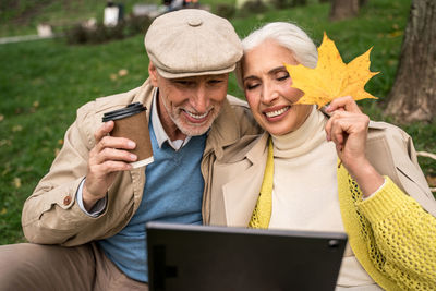 Couple holding smart phone outdoors