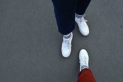 Low section of person standing on road