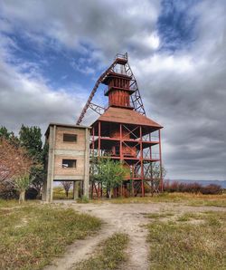 Old building on field against sky