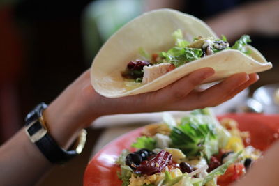 Close-up of woman holding tortilla