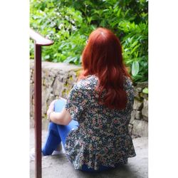 Rear view of woman standing with umbrella