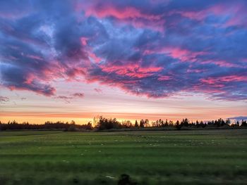 Scenic view of field against sky during sunset