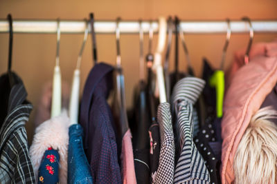 Close-up of clothes hanging on rack in store